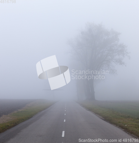 Image of Asphalt road into the fog