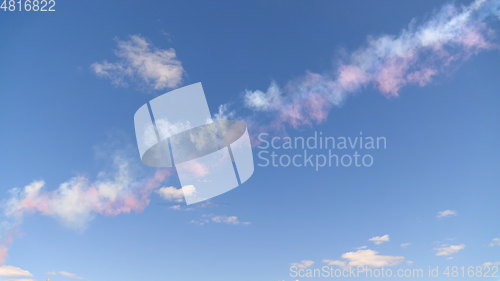 Image of Beautiful three colored clouds on a blue sky.