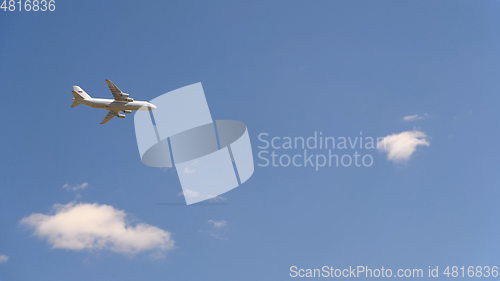 Image of Military transport aircraft An-124 fly in blue sky