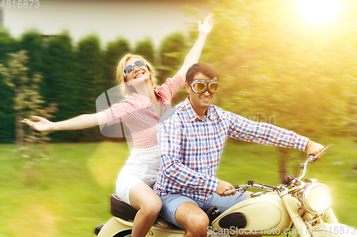 Image of beautiful couple on retro motorbike