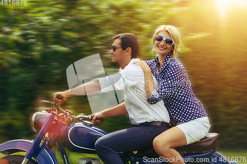 Image of beautiful couple on retro motorbike