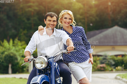 Image of beautiful couple on retro motorbike