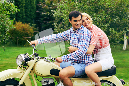 Image of beautiful couple on retro motorbike