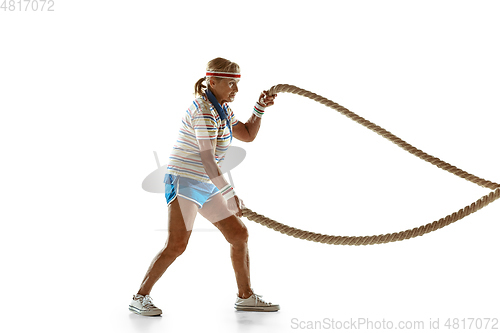 Image of Senior woman training with ropes in sportwear on white background