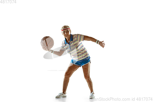 Image of Senior woman playing basketball in sportwear on white background