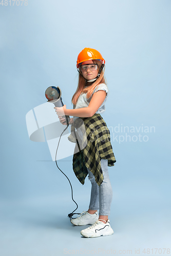 Image of Girl dreaming about future profession of engineer