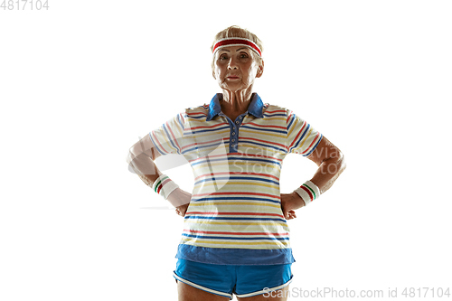 Image of Senior woman training and posing in sportwear on white background