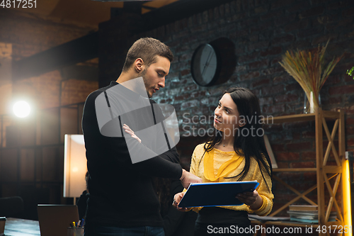 Image of Colleagues working together in modern office using devices and gadgets during creative meeting