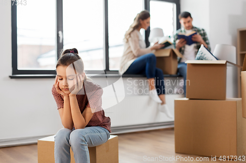 Image of sad girl moving to new home with her family