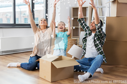 Image of happy family playing with foam peanuts at new home