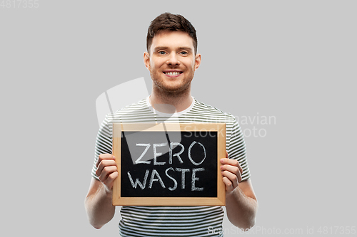 Image of smiling man holding chalkboard with zero waste