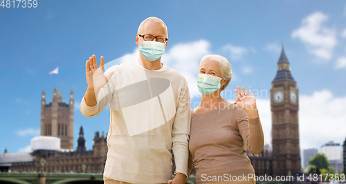 Image of senior couple in medical masks in london