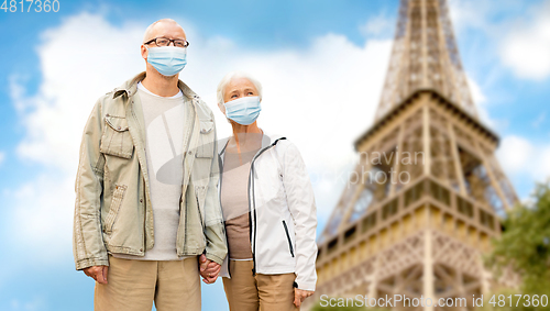 Image of old couple in protective medical masks in france