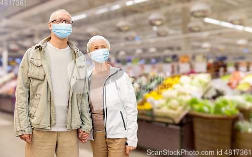 Image of senior couple in medical masks at supermarket