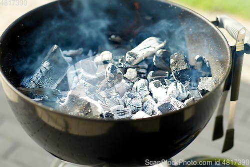 Image of charcoal smoldering in brazier outdoors