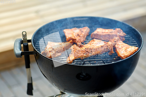 Image of close up of barbecue meat roasting on grill