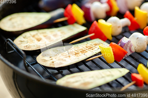 Image of vegetables and mushrooms roasting on brazier grill