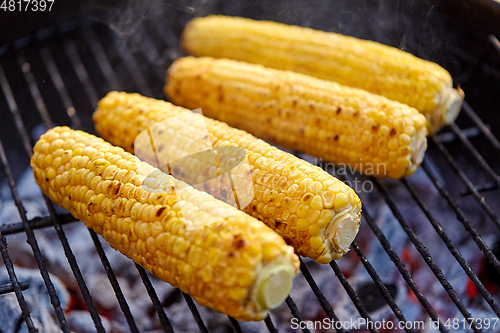 Image of close up of corn roasting on grill