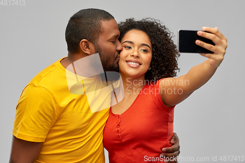 Image of african american couple takes selfie by smartphone