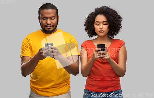 Image of african american couple with smartphones