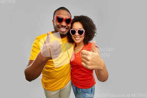 Image of happy african couple in heart shaped suglasses