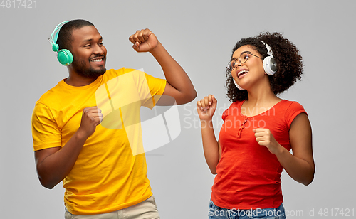 Image of african american couple with headphones dancing