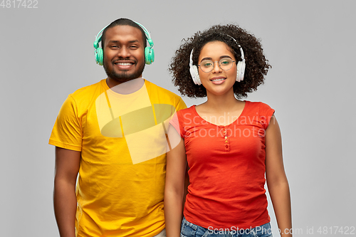 Image of happy african american couple with headphones