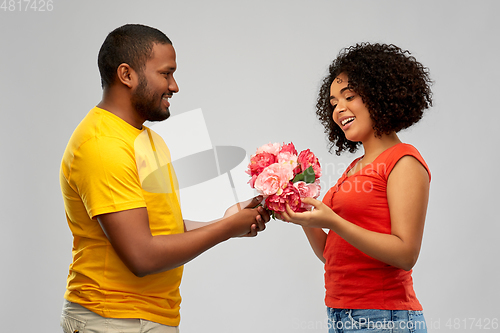 Image of happy african american couple with flowers