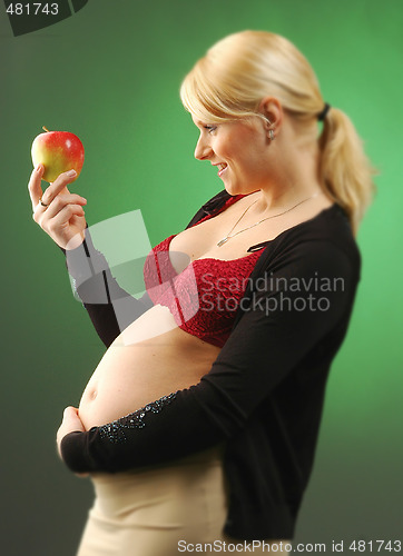 Image of Pregnant woman with apple