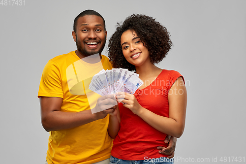 Image of happy african american couple with euro money