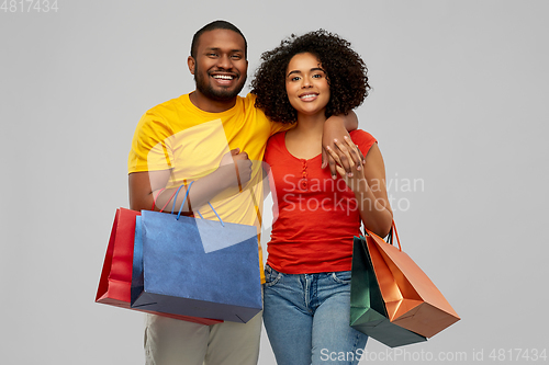 Image of happy african american couple with shopping bags