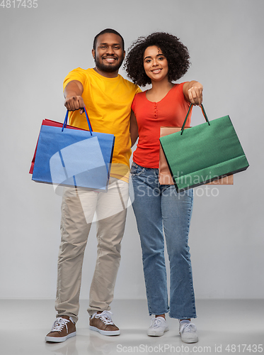 Image of happy african american couple with shopping bags