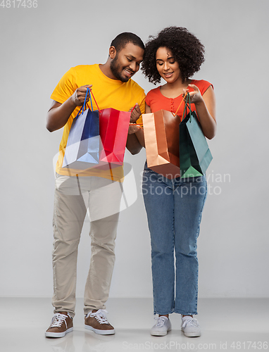 Image of happy african american couple with shopping bags