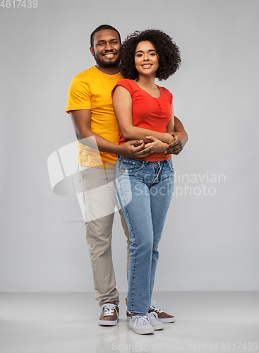 Image of happy african american couple hugging
