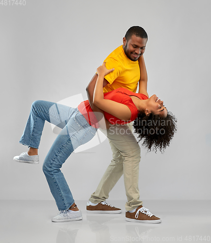 Image of happy smiling african american couple dancing