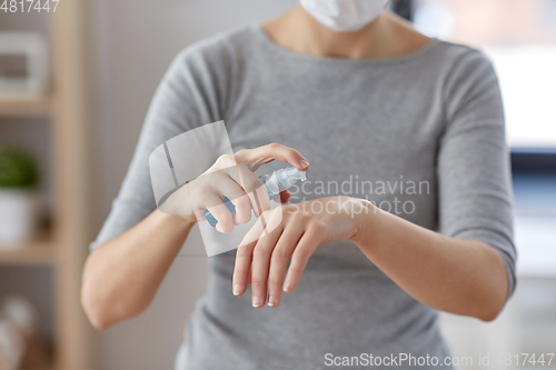 Image of close up of woman spraying hand sanitizer