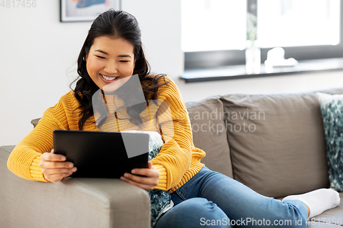 Image of asian young woman with tablet pc computer at home