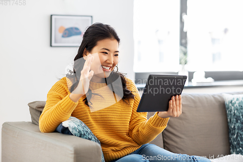 Image of woman with tablet pc having video call at home