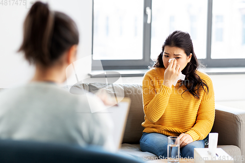 Image of crying woman patient at psychotherapy session