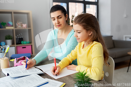 Image of mother and daughter doing homework together
