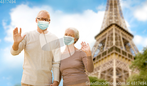 Image of old couple in protective medical masks in france