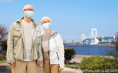 Image of senior couple in protective medical masks in japan