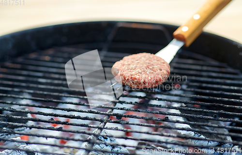 Image of close up of meat cutlets roasting on grill