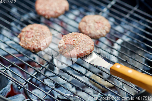 Image of close up of meat cutlets roasting on grill