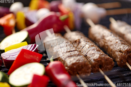 Image of close up of barbecue kebab meat roasting on grill