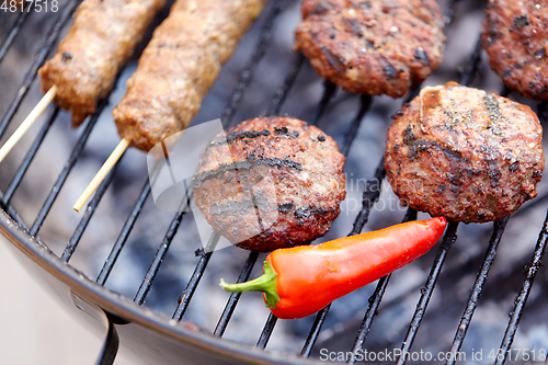 Image of barbecue kebab meat and pepper roasting on grill