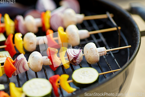 Image of vegetables and mushrooms roasting on brazier grill