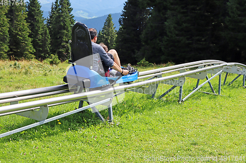 Image of Father and son enjoying a summer fun roller alpine coaster ride