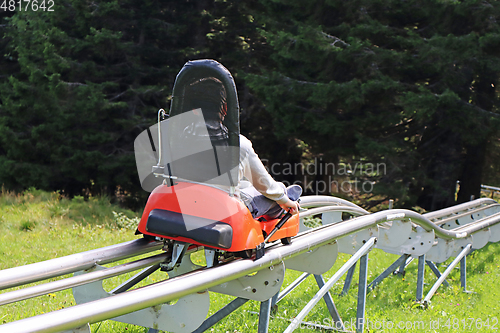 Image of Little boy enjoying a summer fun roller alpine coaster ride