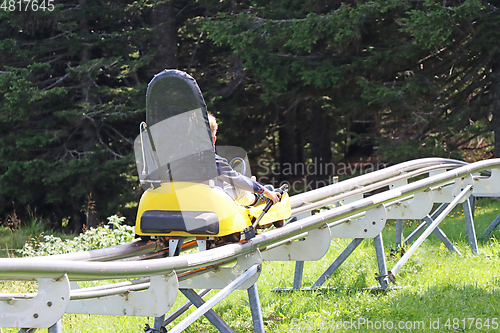 Image of Little boy enjoying a summer fun roller alpine coaster ride